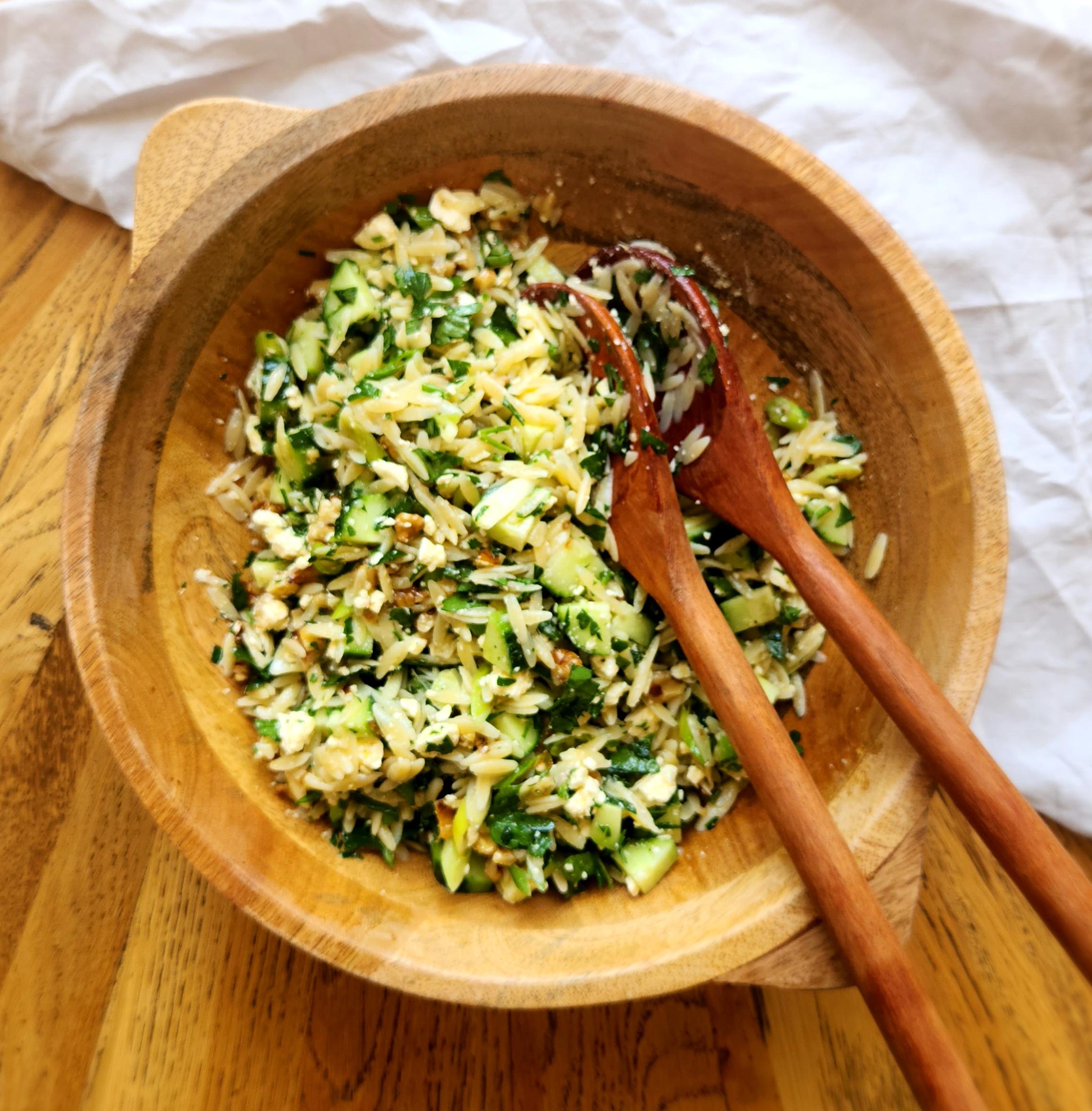 the combined salad with salad servers in the bowl