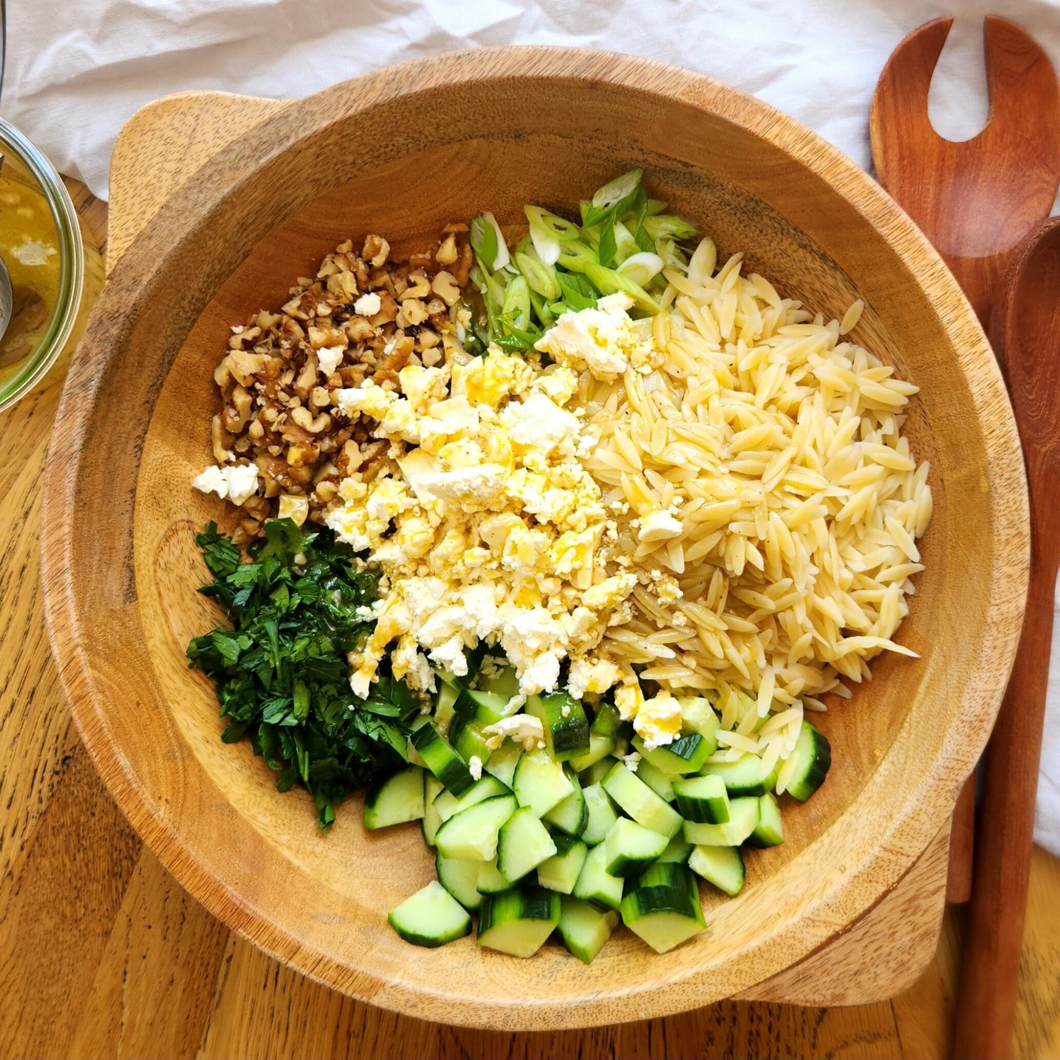 salad dressing poured over the ingredients in a bowl