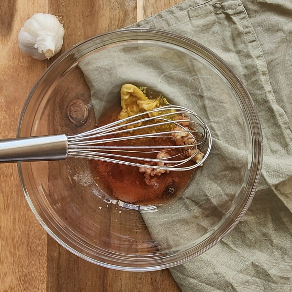 vinegar, mustard, salt and pepper added to the bowl